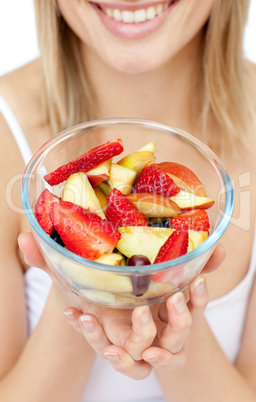 Close-up of a woman holding a fruit salad