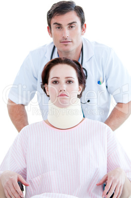 Confident male doctor carrying a patient in a wheelchair