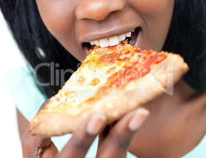 Close-up of a teen girl eating a pizza