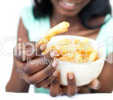 Afro-american young woman eating fries