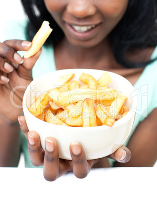 Young woman eating fries