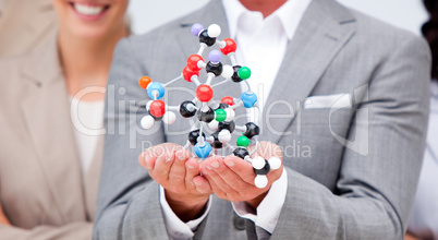 Close-up of a businessman holding a molecule