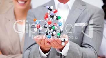 Close-up of a businessman holding a molecule