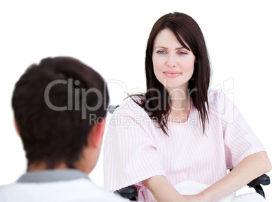 Female patient in a wheelchair interacting with her doctor