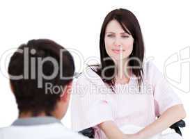 Female patient in a wheelchair interacting with her doctor