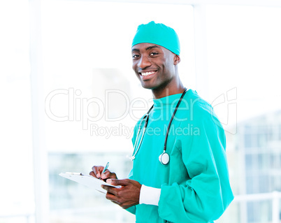 Attractive surgeon making notes in a patient's folder
