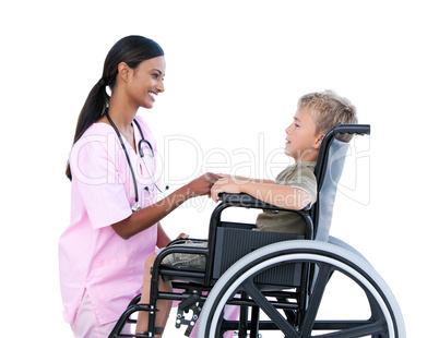 Ciute little boy in a wheelchair discussing with his doctor