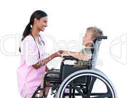 Ciute little boy in a wheelchair discussing with his doctor