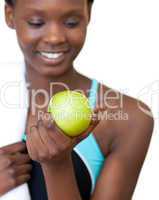 Close-up of a fitness woman eating an apple