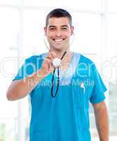 Positive male doctor holding a stethoscope