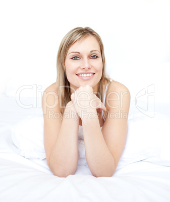 Portrait of a beautiful woman sitting oon her bed
