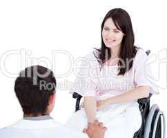 Smiling female patient in a wheelchair interacting with her doct