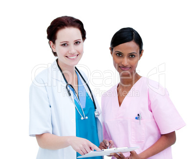 Sel-assured female doctor and nurse studying a patient's folder