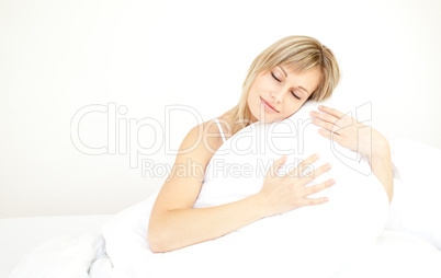 Beautiful woman hugging her pillow