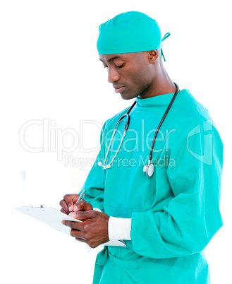 Charismatic male surgeon making notes in a patient's folder