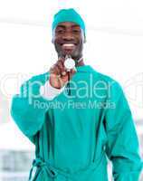 Smiling male doctor holding a stethoscope