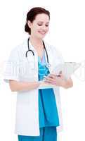 Charming female doctor making notes in a patient's folder