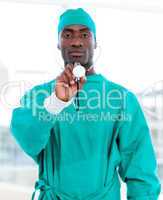 Handsome male doctor holding a stethoscope
