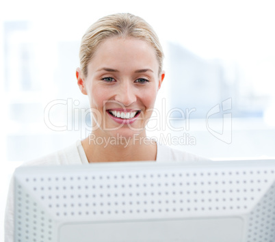 Charming businesswoman working at a computer