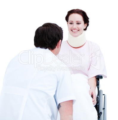 Smiling young woman in a wheelchair discussing with her doctor