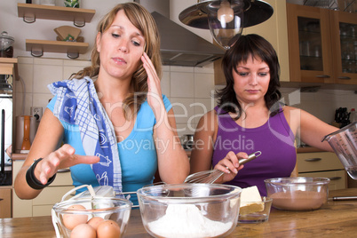 Two girl baking in the kitchen