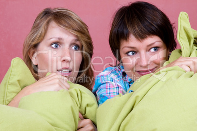 Two girl watching a scary movie
