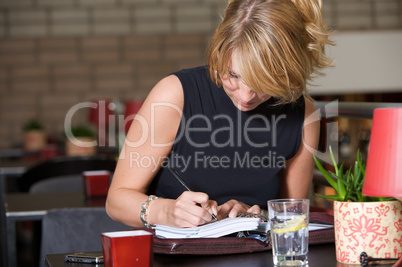 Writing in her notebook