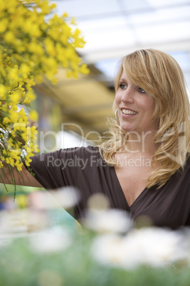 Pretty blond woman in garden center