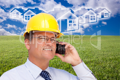 Contractor in Hardhat on Phone Over House, Grass and Clouds