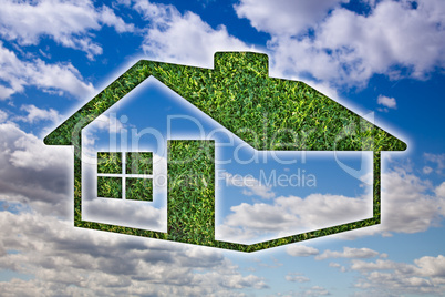 Green Grass House Icon over Sky and Clouds