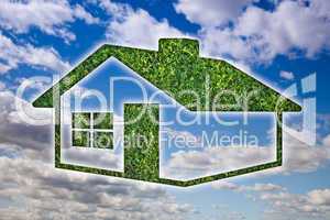 Green Grass House Icon over Sky and Clouds