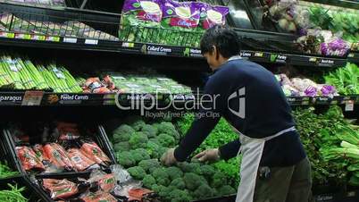 Man Facing Broccoli In Produce