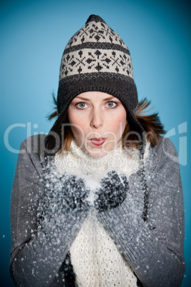 Woman blowing snow