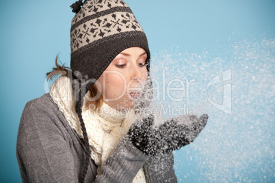 Woman blowing the snow