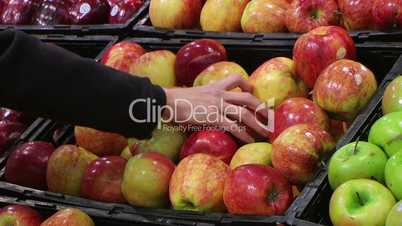 Woman Selecting Apples In Produce