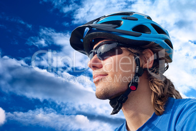 portrait of a young bicyclist in helmet and glasses