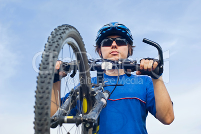 young bicyclist in helmet