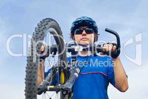 young bicyclist in helmet