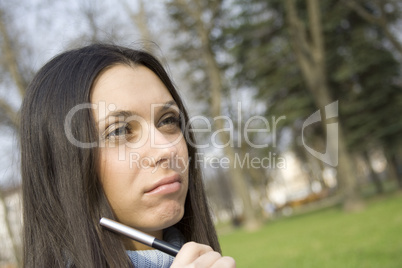 Young woman is thinking in the park