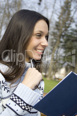 Young woman is thinking in the park