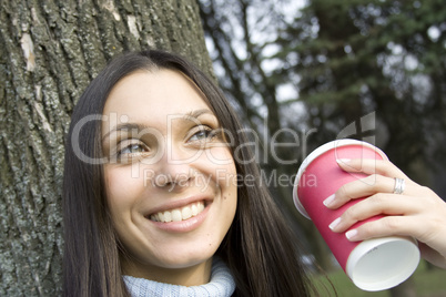 Female in a park drinking coffee