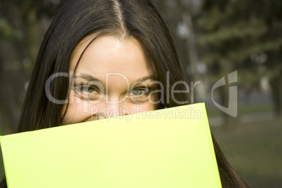 Female hiding behind a folder