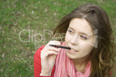 Young woman is thinking in the park