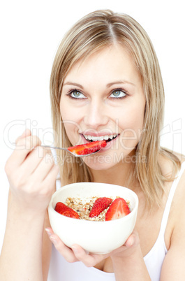 Charming woman eating cereals with strawberries