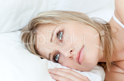 Beautiful woman relaxing lying on her bed
