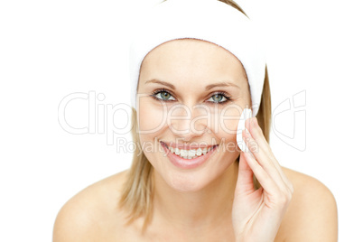 Smiling woman putting foundation cream