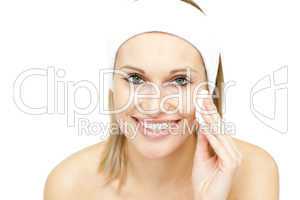 Smiling woman putting foundation cream