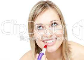 Attractive blond woman putting lipstick