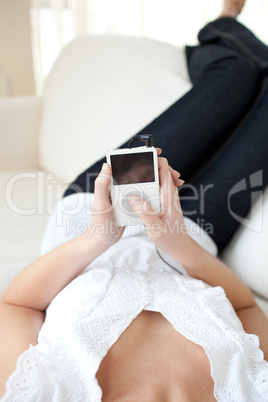 Young woman listening music lying on a sofa