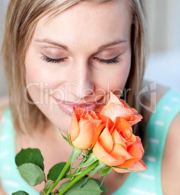 Smiling woman smelling roses